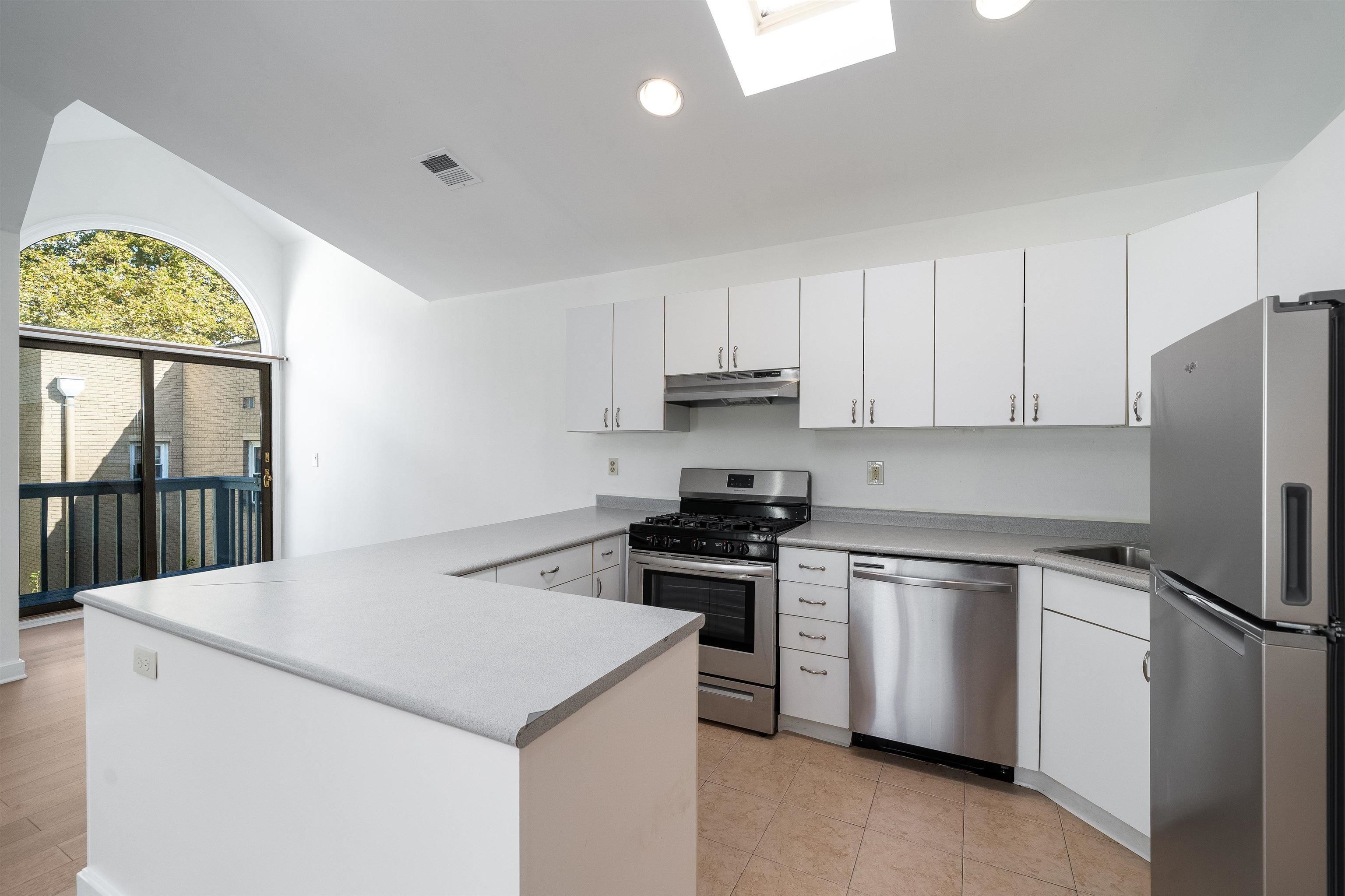 Modern kitchen with stainless appliances and white cabinetry