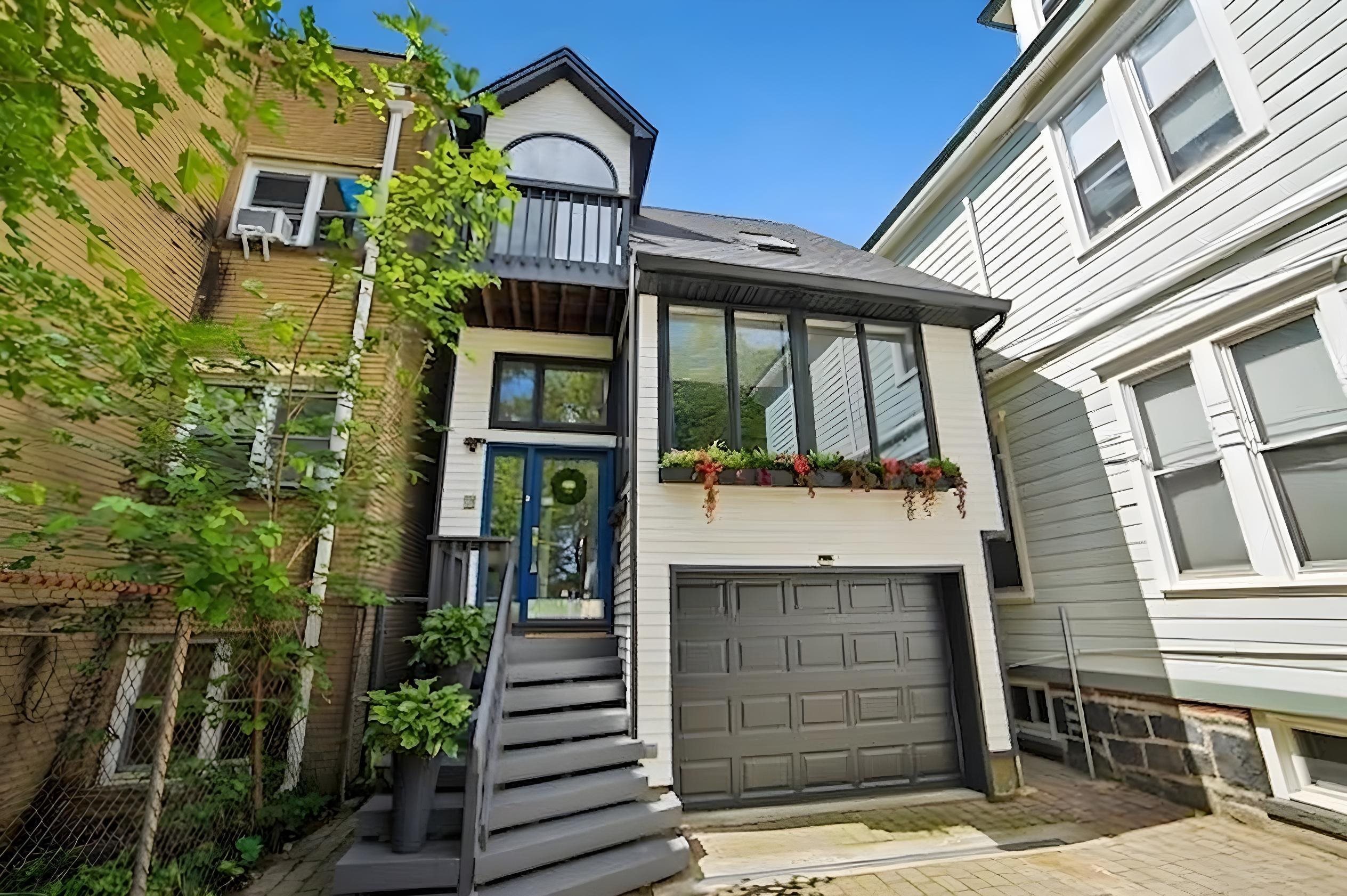 Front elevation of 79 Sherman Place showing contemporary design with blue entry door