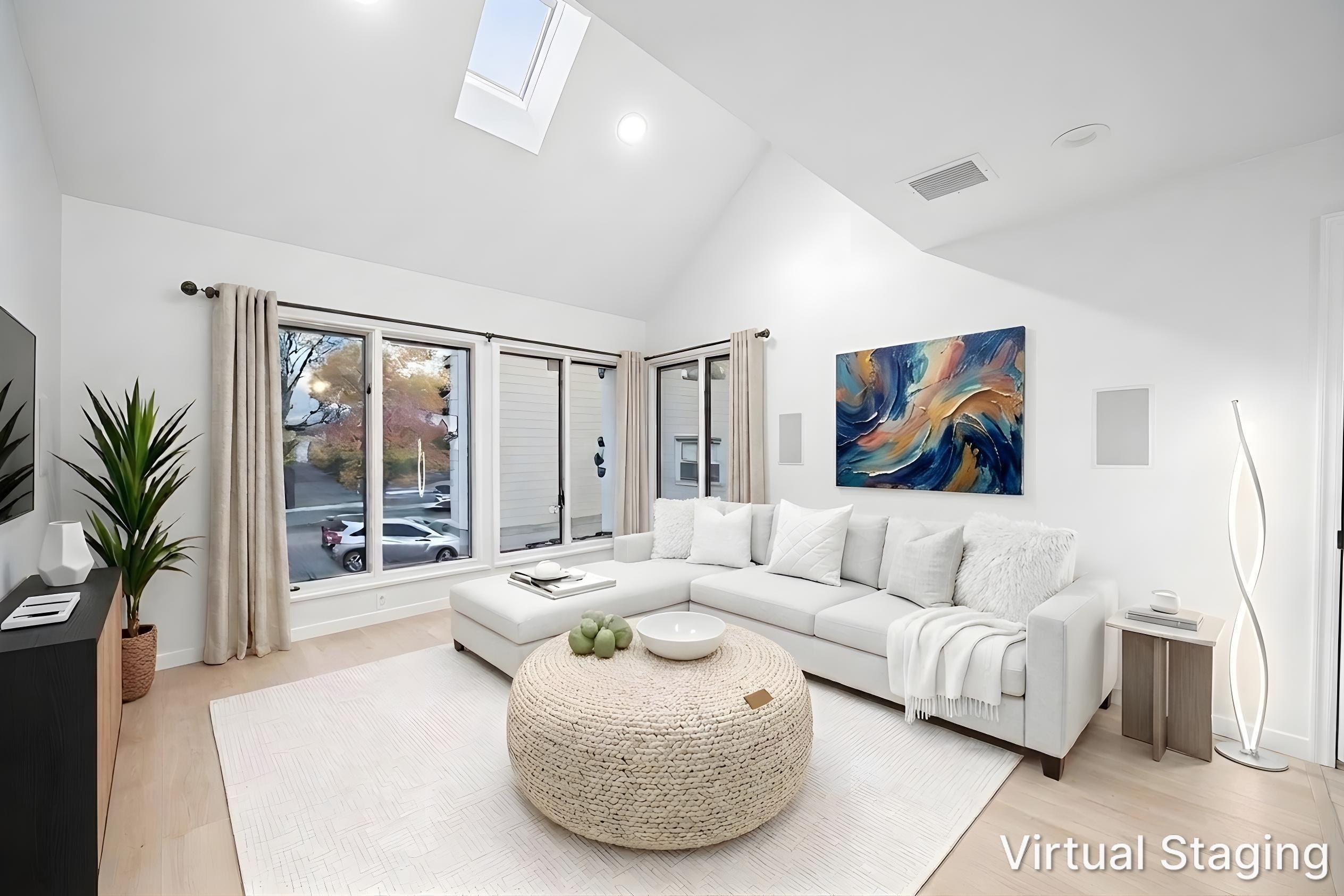 Open living room with white walls and natural light
