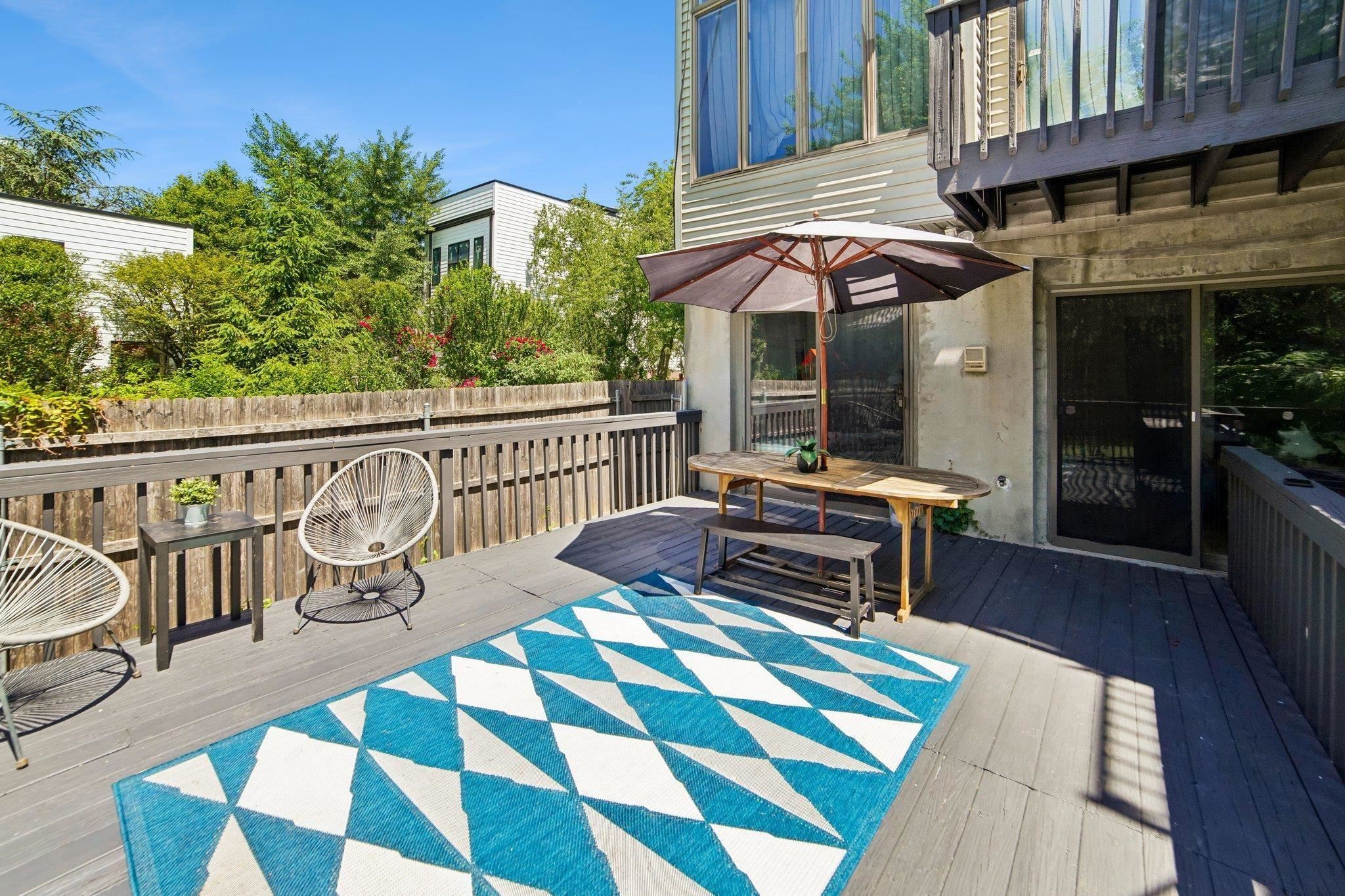 Deck with outdoor furniture looking out to the backyard