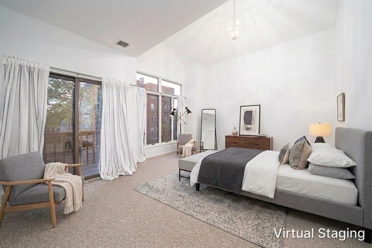 Spacious primary bedroom with sliding glass doors to private balcony
